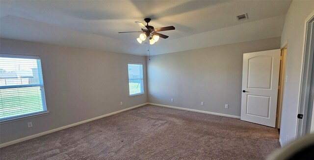 empty room with ceiling fan and carpet