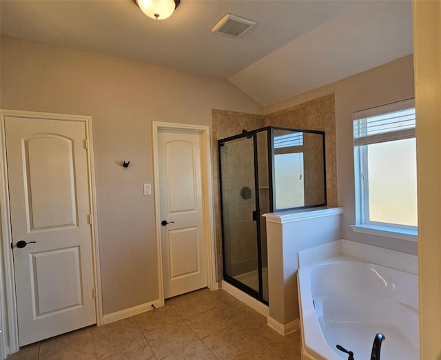 bathroom with tile patterned flooring, vaulted ceiling, and plus walk in shower