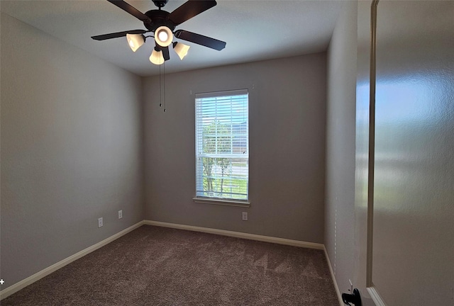 spare room with ceiling fan and carpet