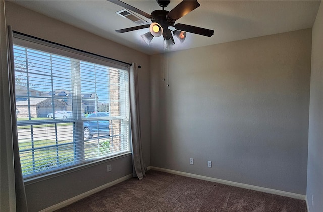 carpeted spare room featuring ceiling fan