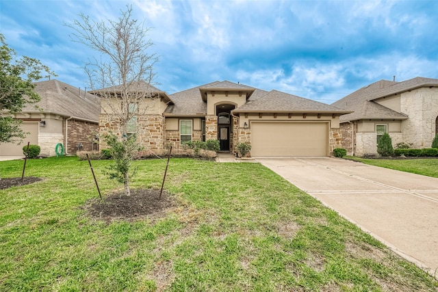 view of front of home with a garage and a front lawn