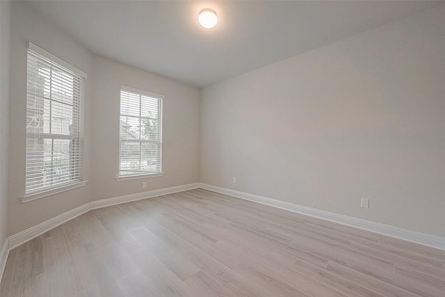 empty room with light hardwood / wood-style flooring