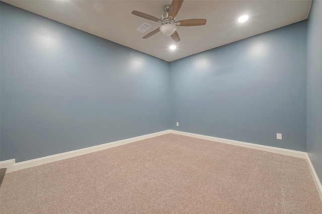 carpeted spare room featuring ceiling fan