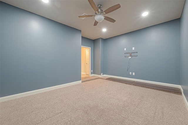 spare room featuring carpet and ceiling fan