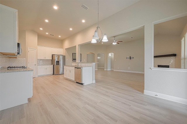 kitchen featuring appliances with stainless steel finishes, light wood-type flooring, white cabinetry, and ceiling fan