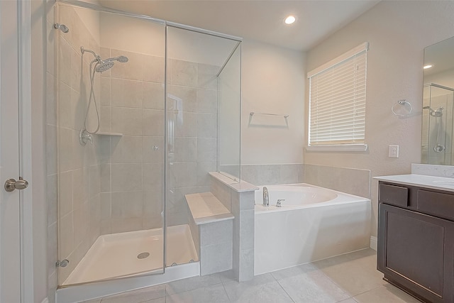 bathroom featuring vanity, tile patterned flooring, and plus walk in shower