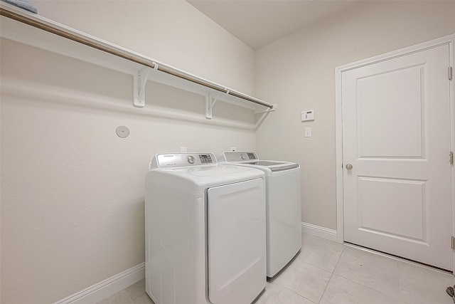 laundry area featuring independent washer and dryer and light tile patterned flooring