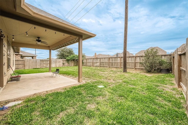 view of yard featuring ceiling fan and a patio