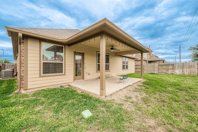 rear view of property with central AC unit, ceiling fan, a patio area, and a lawn