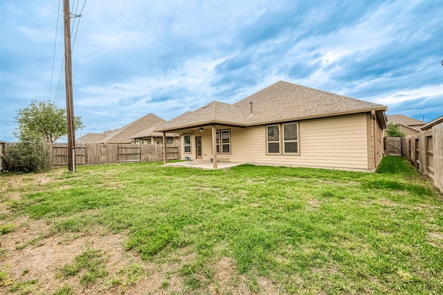 back of property featuring ceiling fan, a patio area, and a lawn