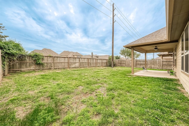 view of yard with a patio area and ceiling fan