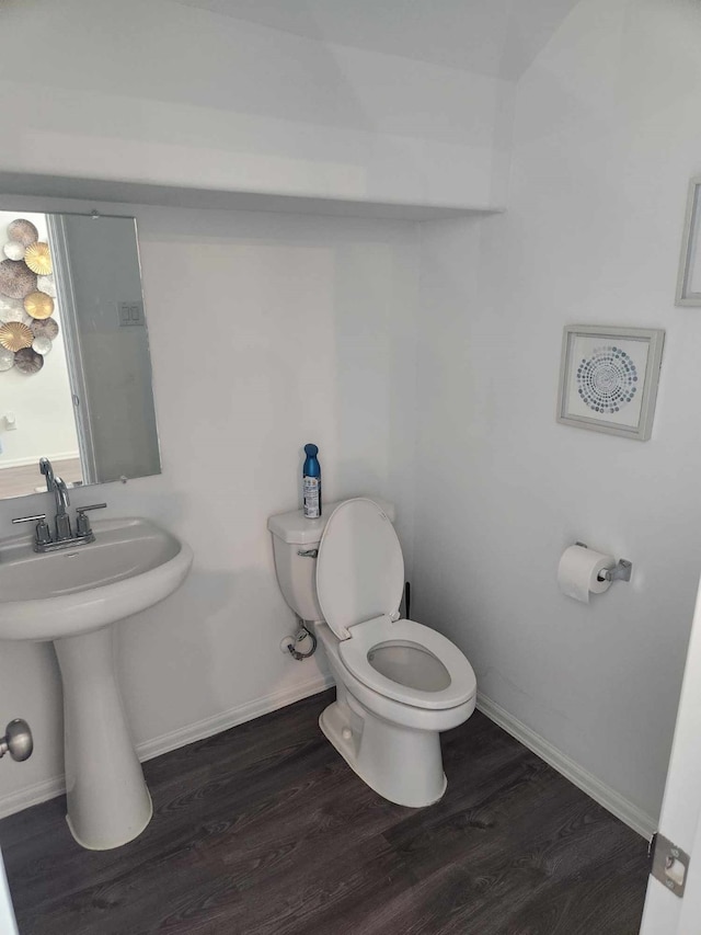 bathroom featuring hardwood / wood-style floors, toilet, and sink