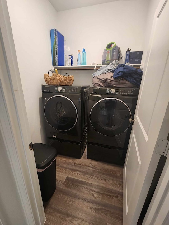 washroom featuring washing machine and clothes dryer and dark hardwood / wood-style floors