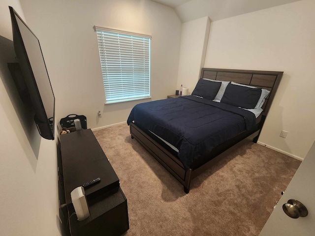 carpeted bedroom featuring vaulted ceiling