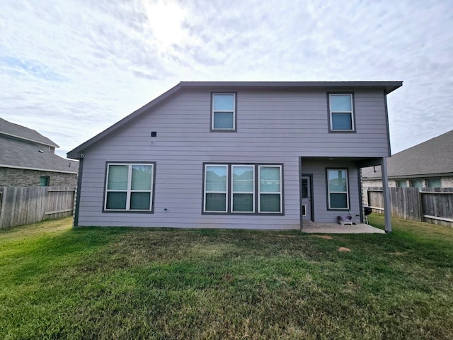 rear view of house featuring a yard