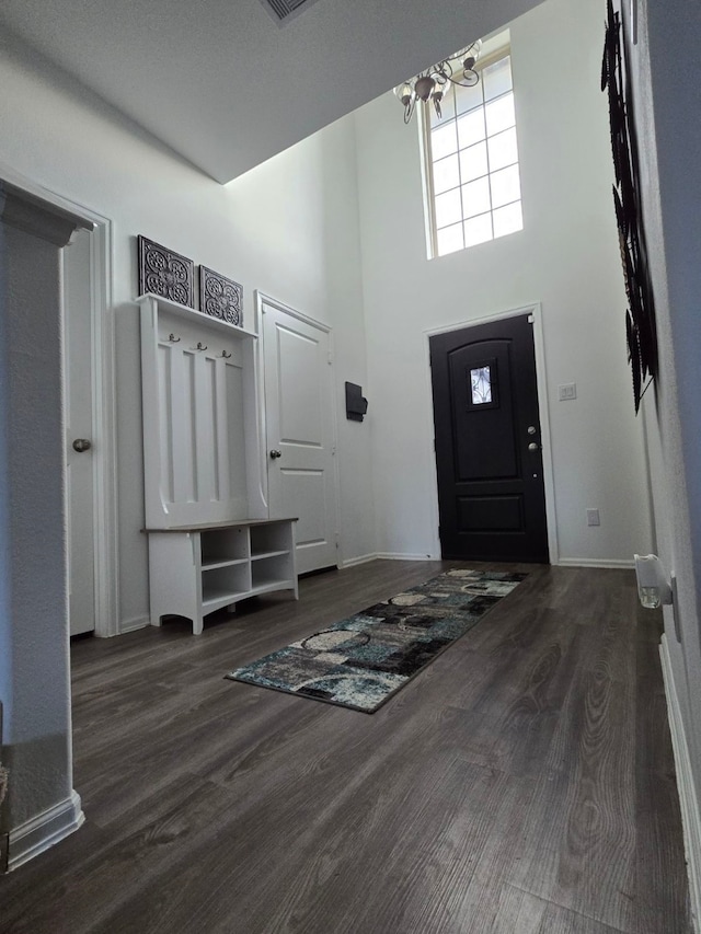 mudroom featuring a chandelier, a high ceiling, dark hardwood / wood-style flooring, and a textured ceiling