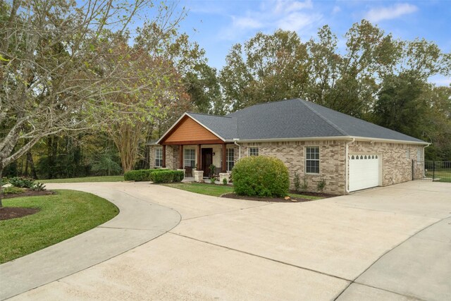 view of front of property with a front yard and a garage