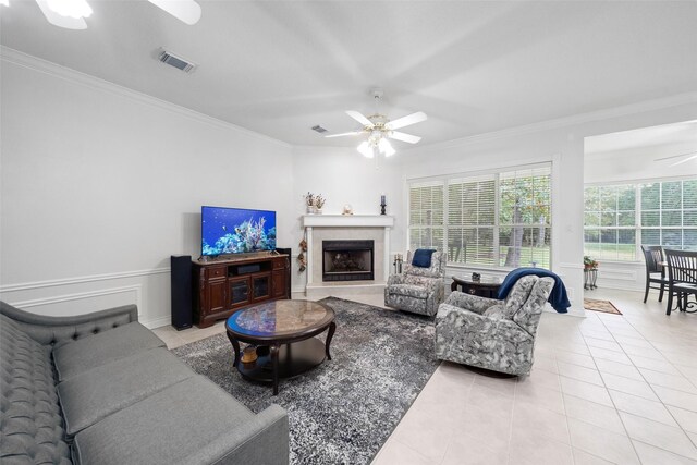 living room with ceiling fan, light tile patterned floors, and crown molding