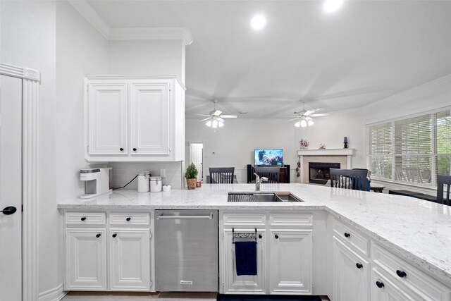 kitchen featuring white cabinetry, kitchen peninsula, light stone countertops, sink, and dishwasher