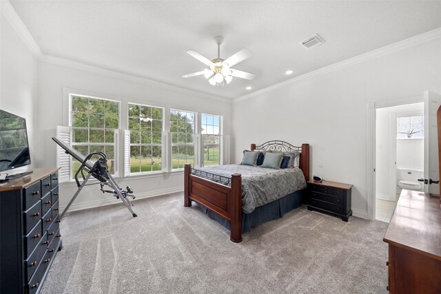 carpeted bedroom with ceiling fan, crown molding, and ensuite bath