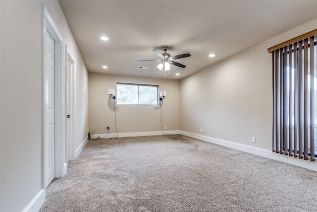 carpeted empty room featuring ceiling fan