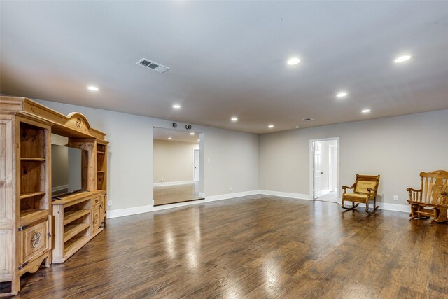 sitting room with dark wood-type flooring