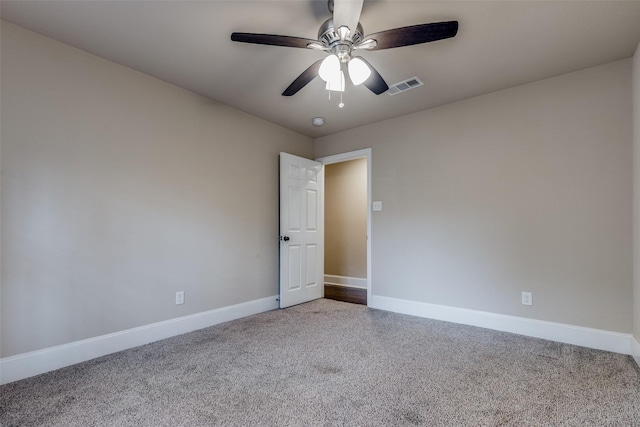 spare room featuring carpet and ceiling fan