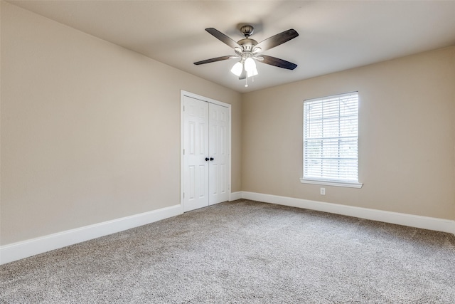 unfurnished bedroom with ceiling fan, carpet floors, and a closet