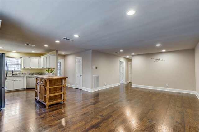 kitchen featuring a kitchen island, dark hardwood / wood-style flooring, white cabinetry, and stainless steel appliances