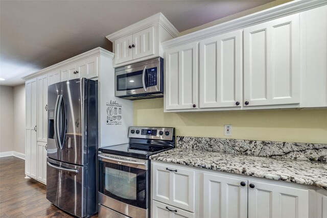 kitchen featuring white cabinets, appliances with stainless steel finishes, and dark wood-type flooring