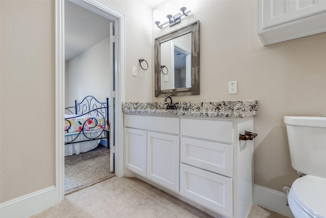 bathroom featuring tile patterned floors, toilet, and vanity