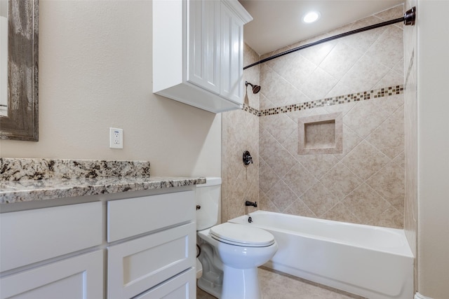 full bathroom with toilet, vanity, and tiled shower / bath