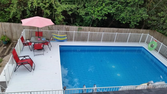 view of swimming pool featuring grilling area