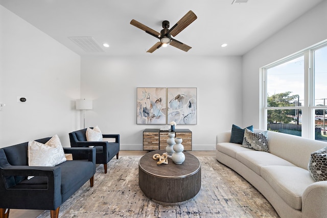 living room featuring hardwood / wood-style flooring and ceiling fan