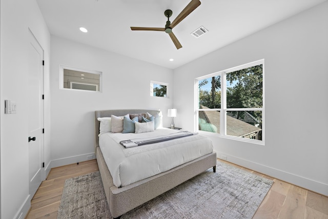 bedroom with ceiling fan and light hardwood / wood-style flooring