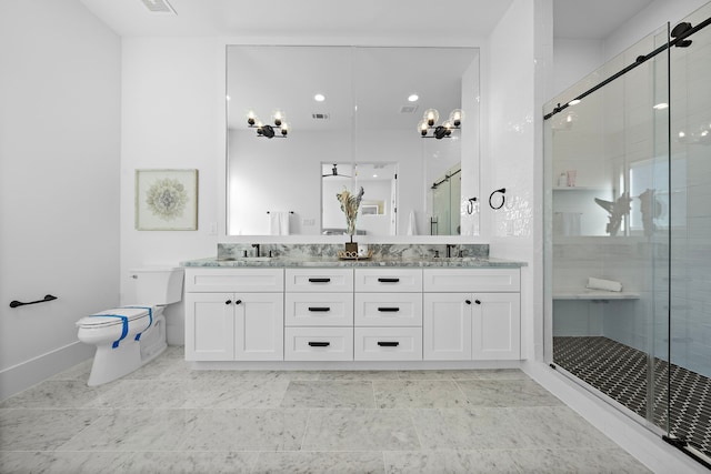 bathroom featuring vanity, toilet, and a shower with door