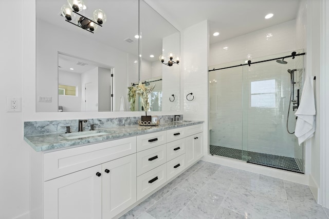 bathroom featuring vanity and a shower with shower door