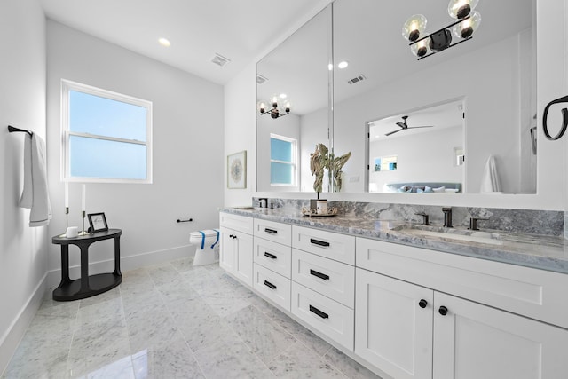 bathroom featuring vanity, toilet, plenty of natural light, and ceiling fan