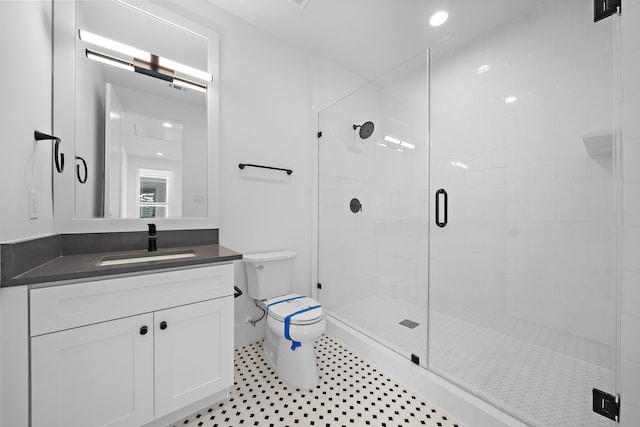 bathroom with toilet, vanity, and walk in shower