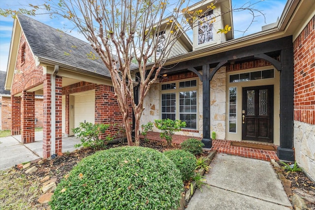 property entrance featuring a porch and a garage