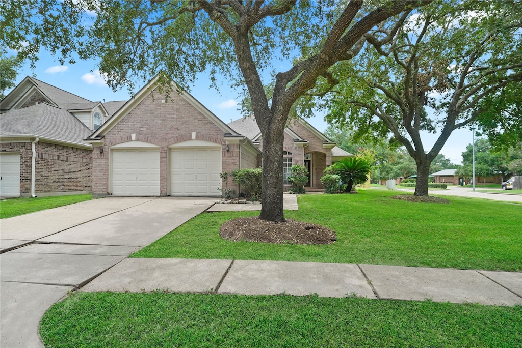 view of front of property with a garage and a front yard