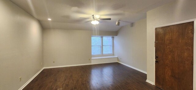 unfurnished room featuring dark hardwood / wood-style flooring, vaulted ceiling, and ceiling fan