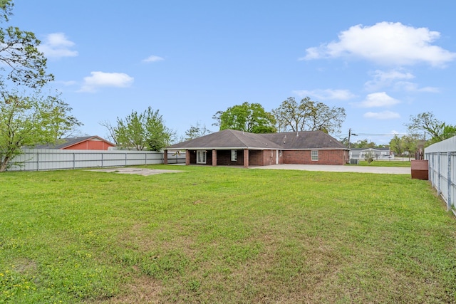 rear view of house featuring a yard