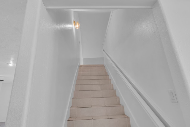 staircase with tile patterned flooring