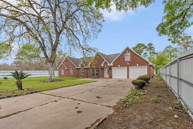 view of front of house featuring a garage and a front lawn