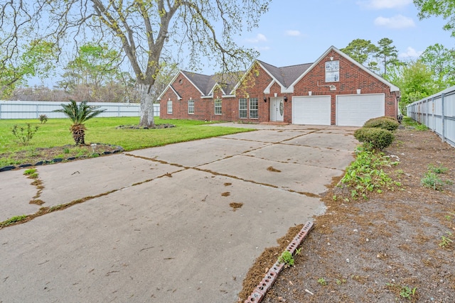 view of front of property featuring a garage and a front yard