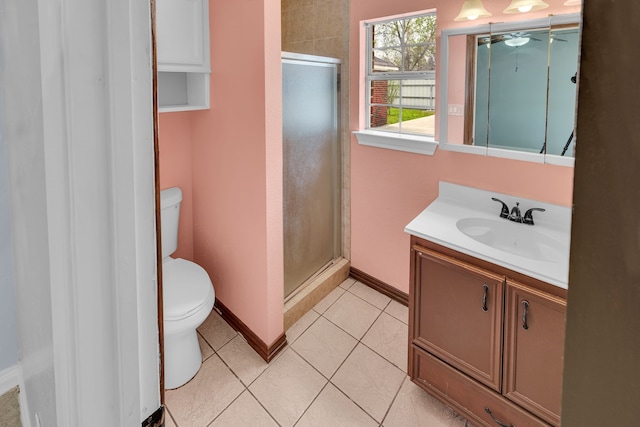 bathroom featuring tile patterned floors, a shower with door, vanity, and toilet