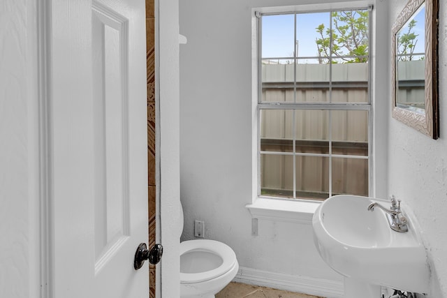 bathroom with sink, tile patterned flooring, and toilet