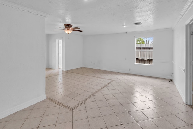 spare room with ceiling fan, light tile patterned flooring, ornamental molding, and a textured ceiling