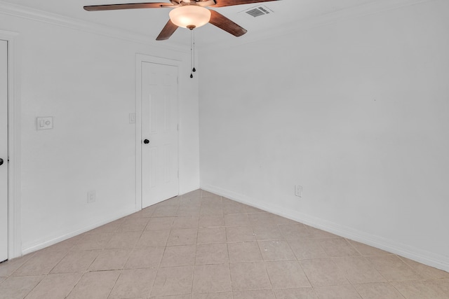 empty room featuring crown molding, light tile patterned floors, and ceiling fan